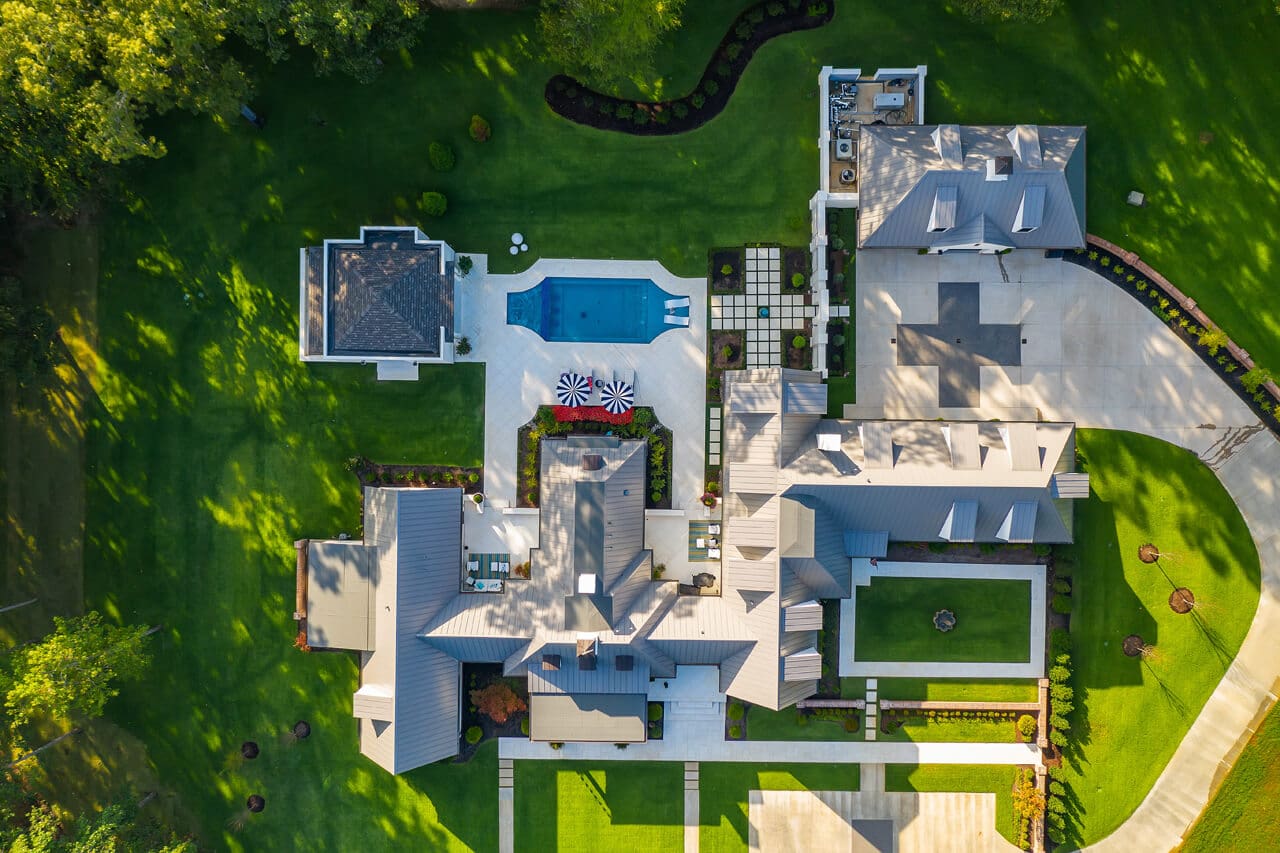 A bird 's eye view of a large house with pool.