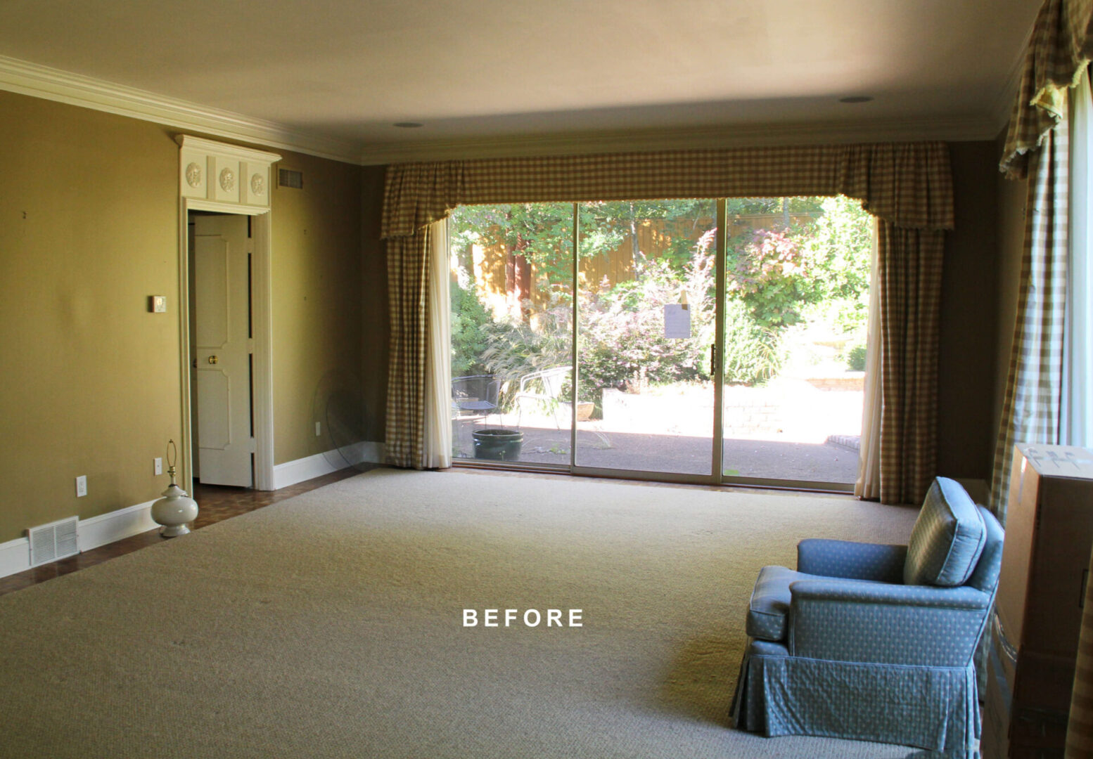 A living room with a large window and a couch