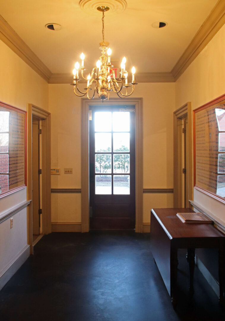 A large room with two windows and a table