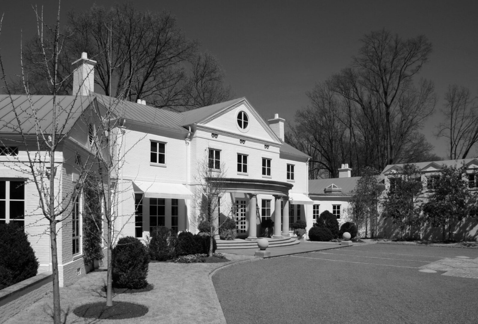 A black and white photo of a large house.