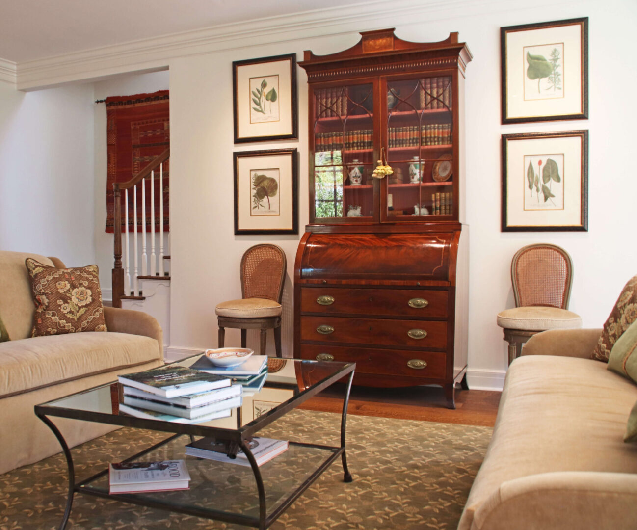 A living room with furniture and pictures on the wall.