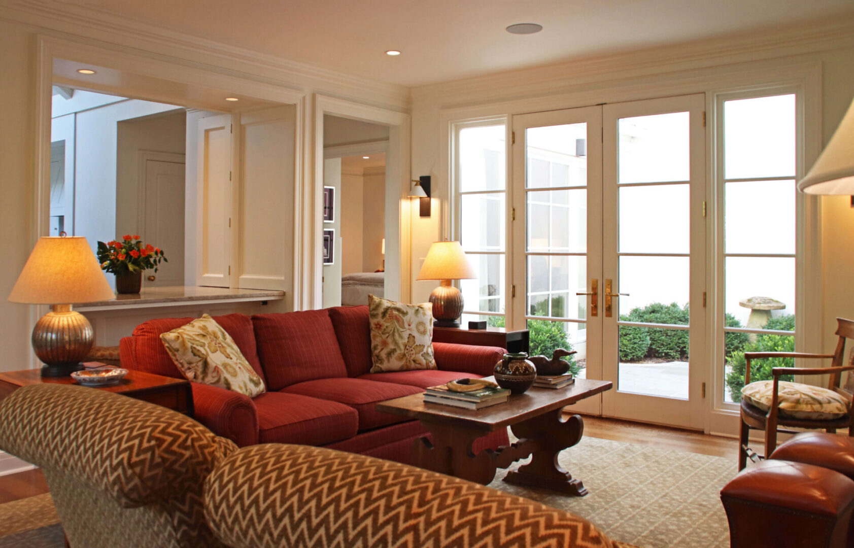 A living room with red couches and a table