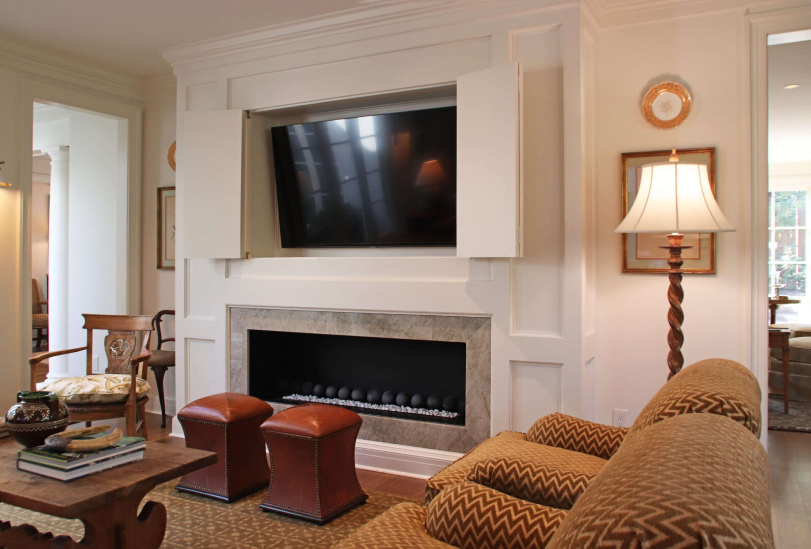 A living room with a fireplace and television.