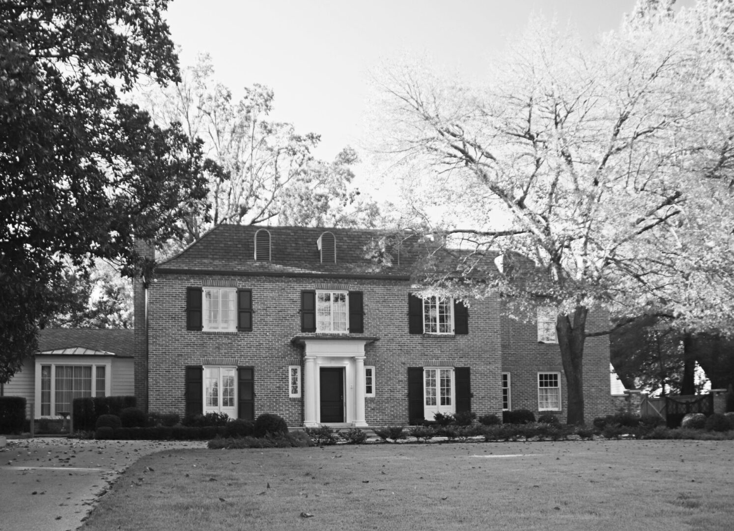 A black and white photo of an old house.