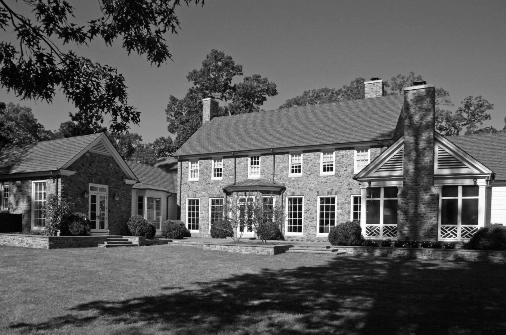 A black and white photo of a large house.