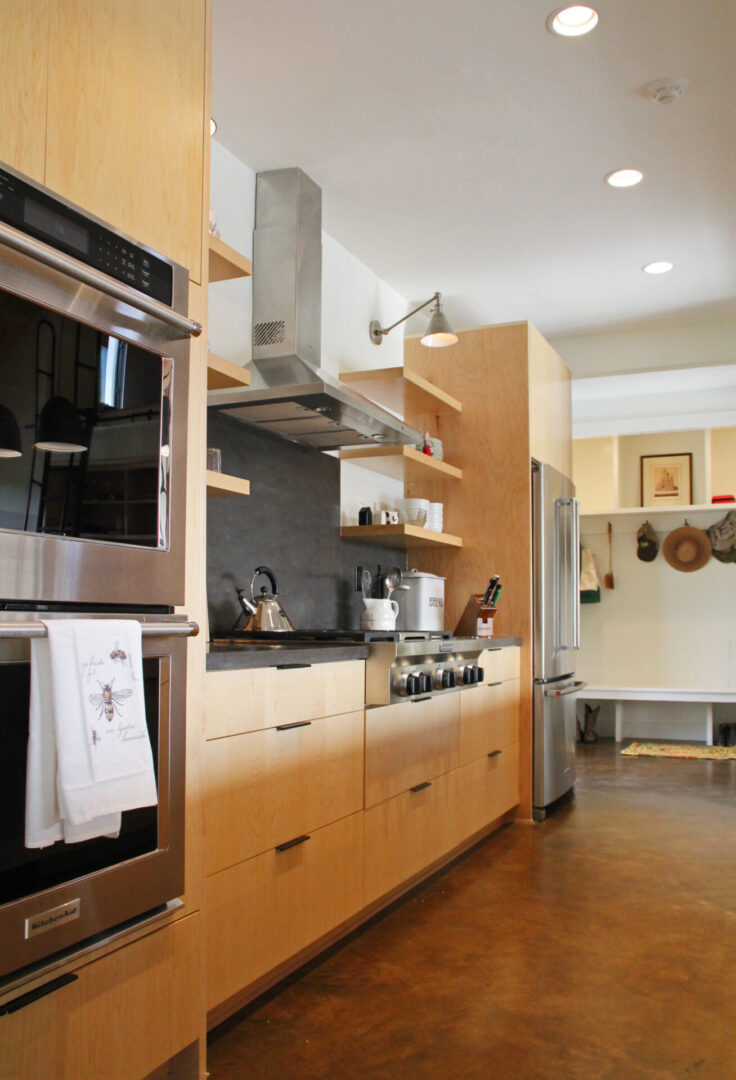 A kitchen with wooden cabinets and stainless steel appliances.