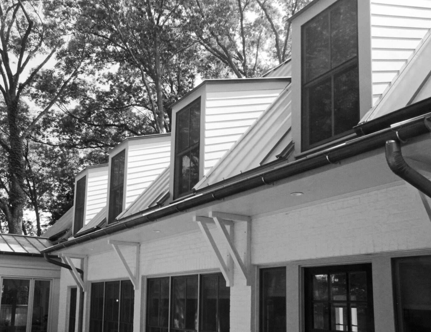 A black and white photo of the side of a house.