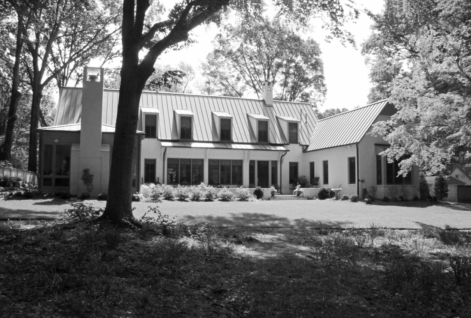 A large white house with trees in front of it.