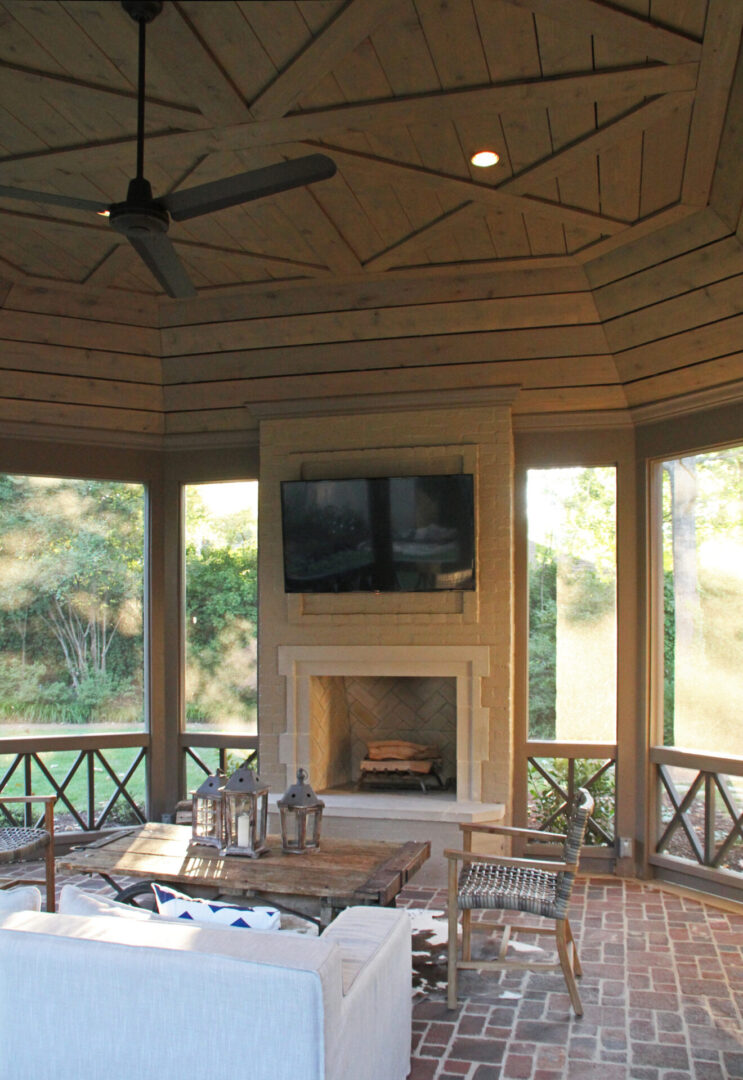 A room with a fireplace and a large screen tv.