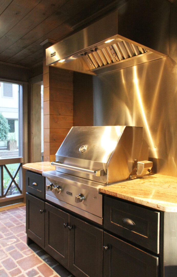 A stainless steel grill in the middle of a kitchen.