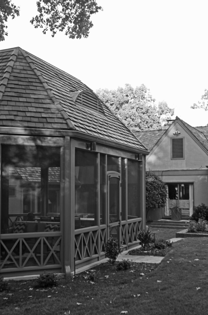 A black and white photo of two houses.