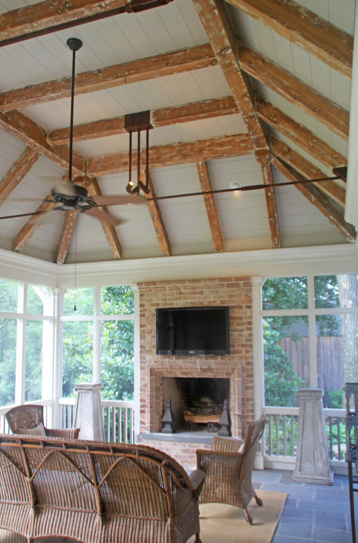 A room with a fireplace and ceiling fan.