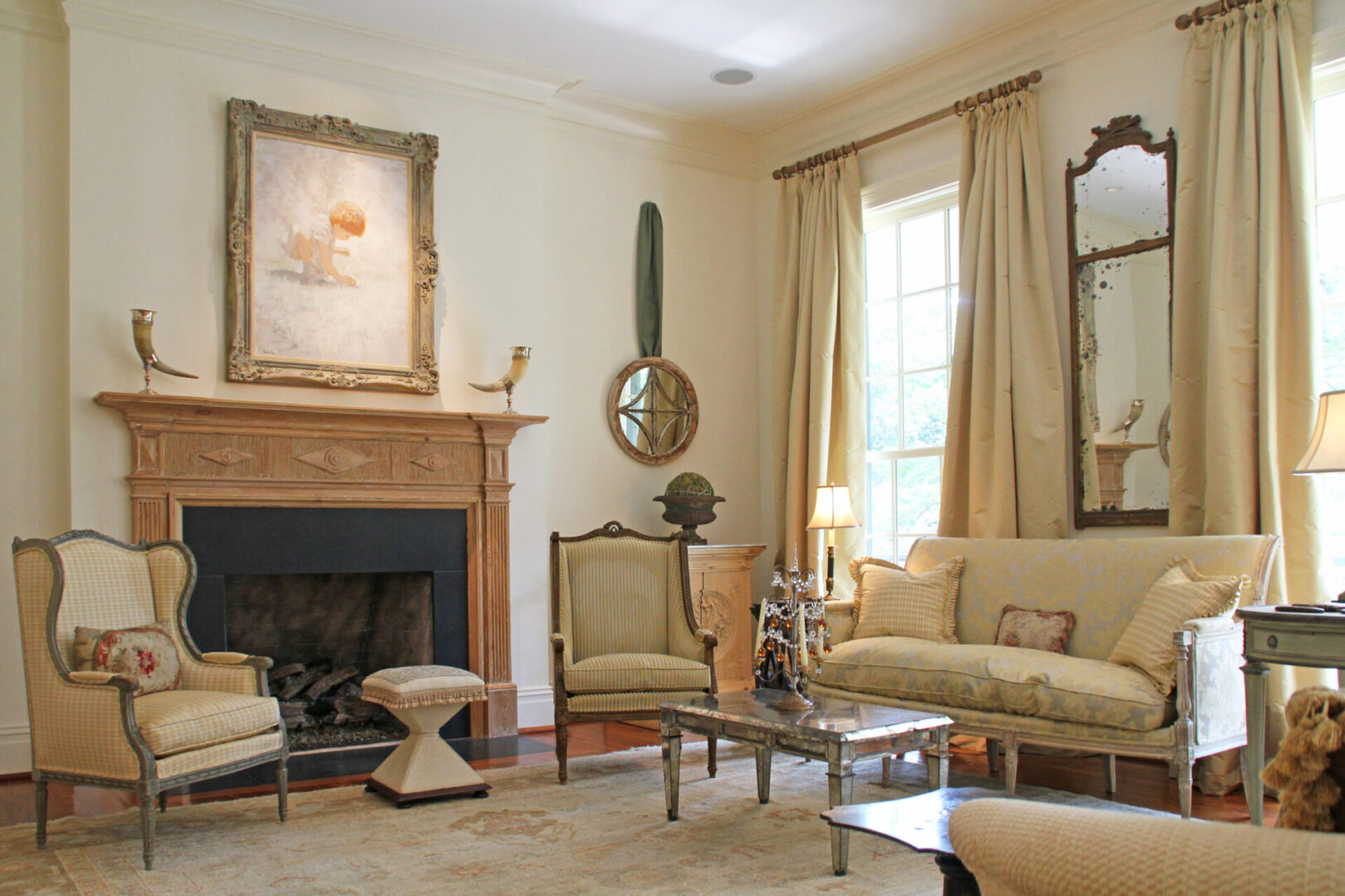 A living room with a fireplace and beige furniture.