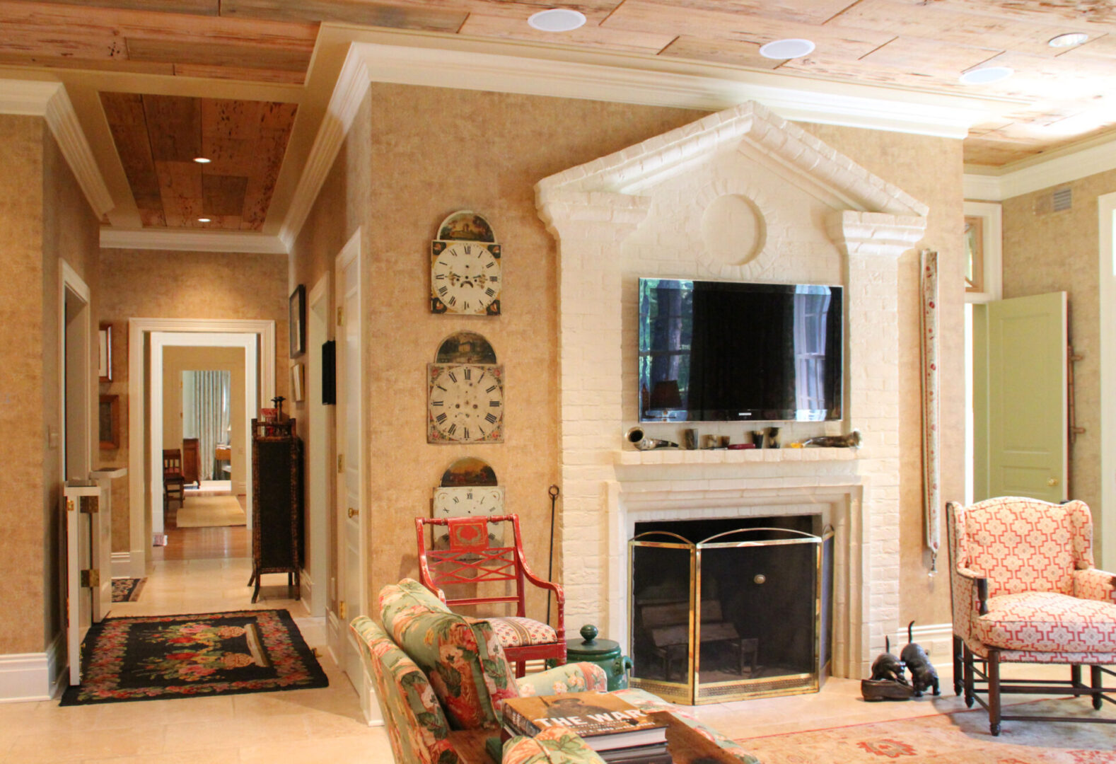 A living room with a fireplace and a television.