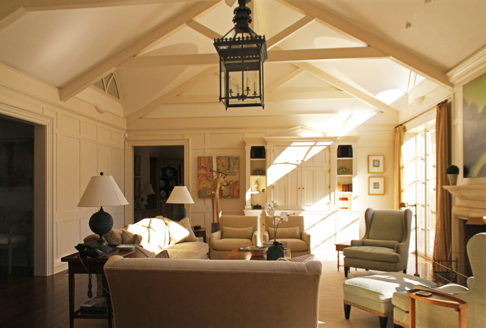 A living room with vaulted ceilings and light fixtures.