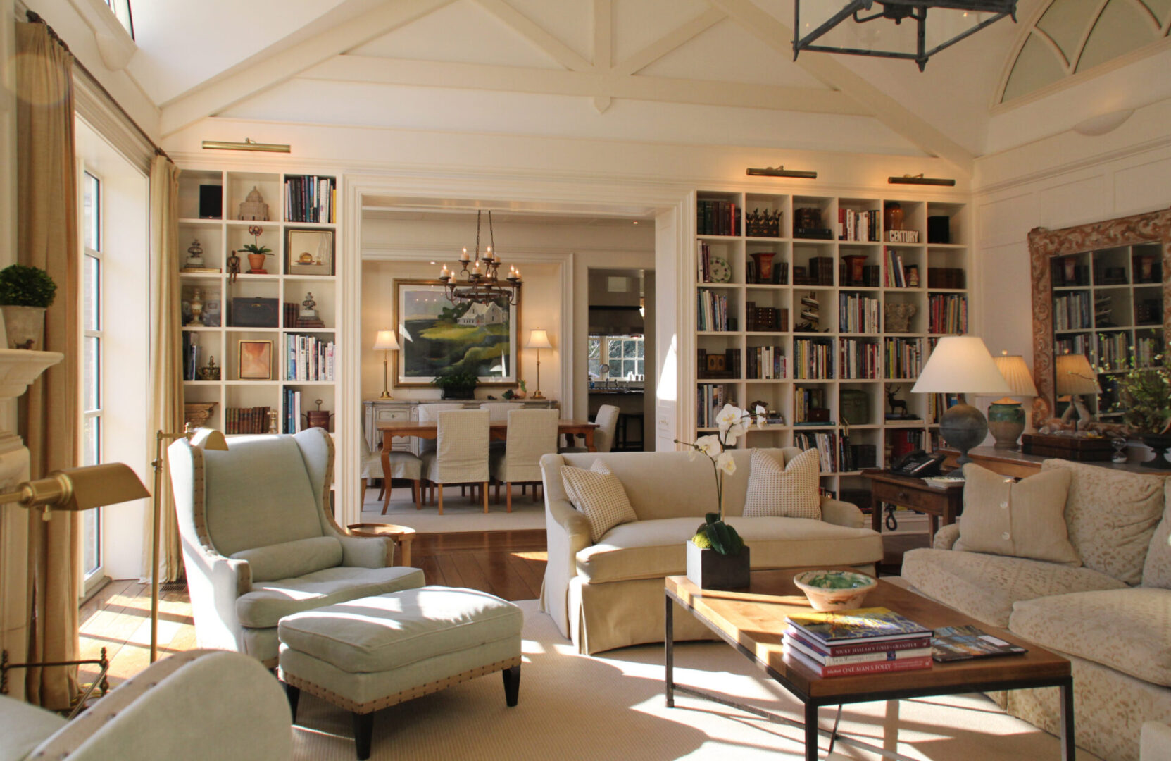 A living room filled with furniture and lots of book shelves.