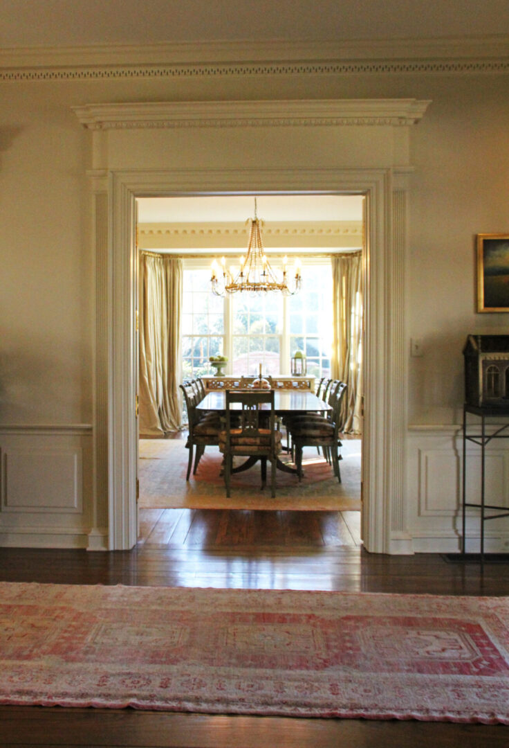 A dining room with a table and chairs in it