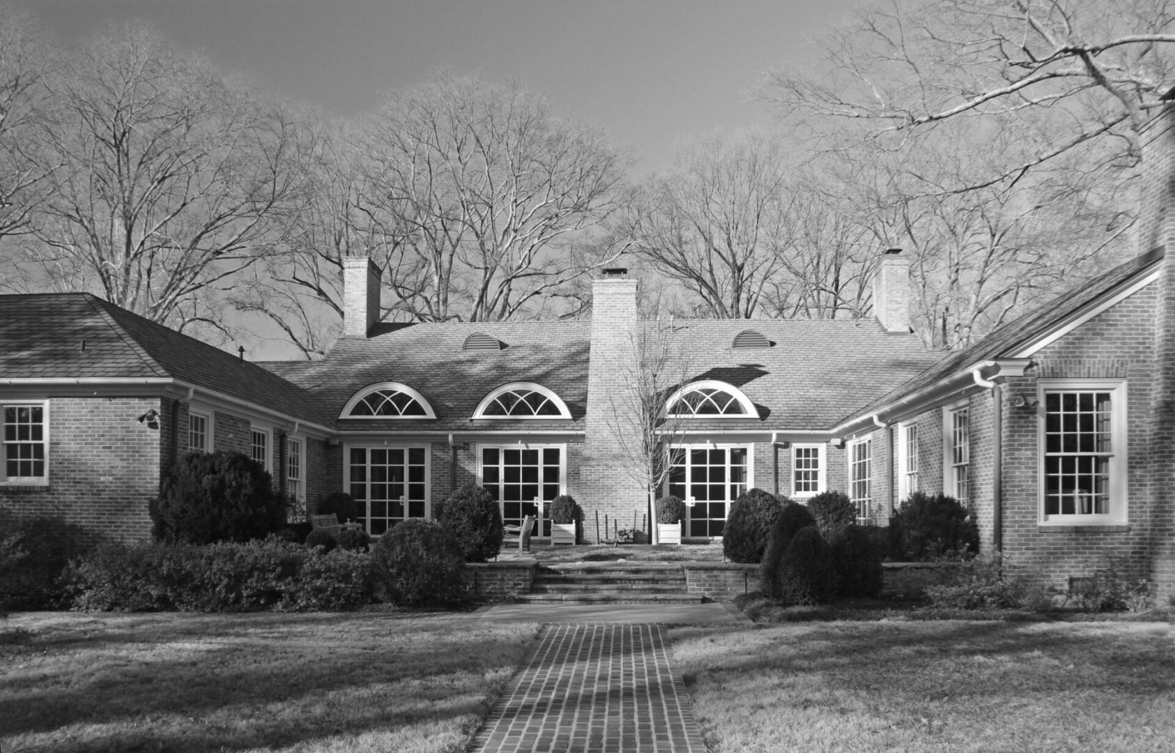 A black and white photo of two houses