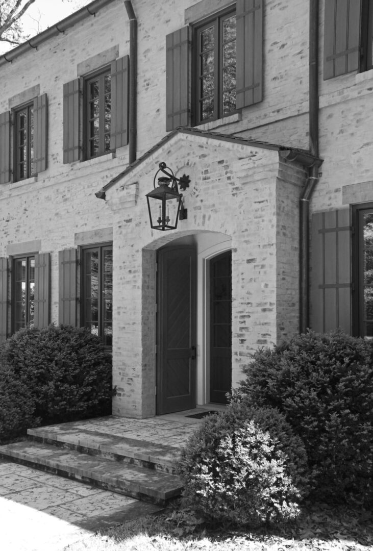 A black and white photo of an old house.