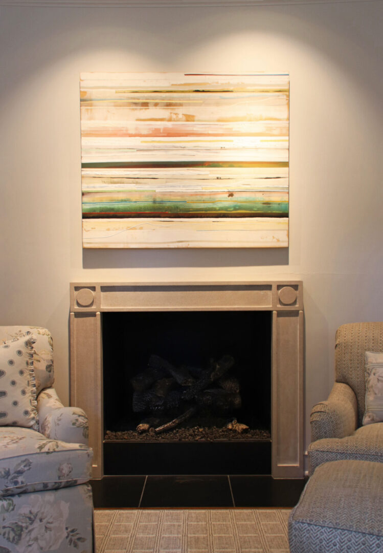 French Provincial fireplace with two couches and a painting on the wall.