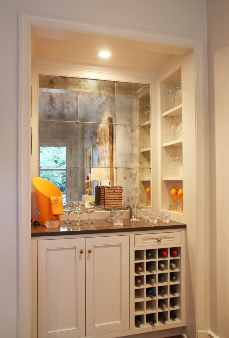 French Provincial wine cellar with marble counter tops and white cabinets.