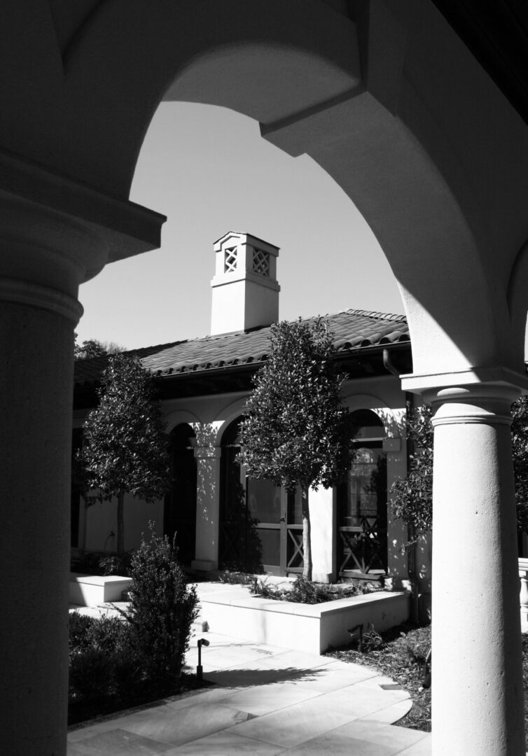 A black and white photo of a building with a clock tower.