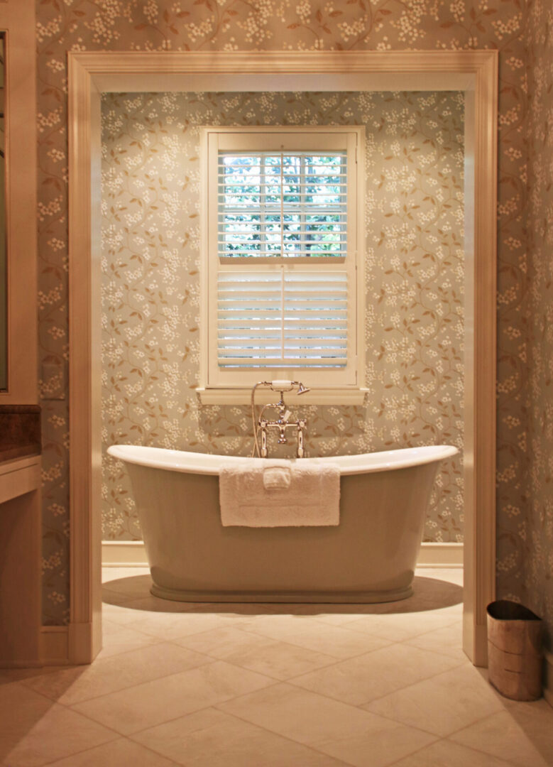 A bathroom with a tub and window in it