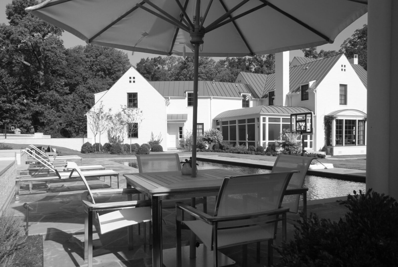 A black and white photo of an outdoor dining area.