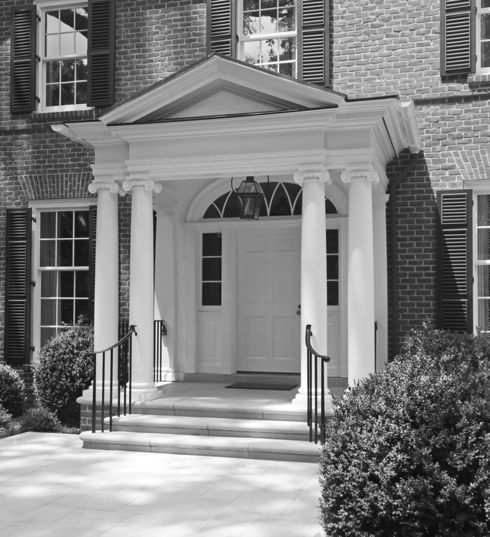 A black and white photo of an entrance to a house.