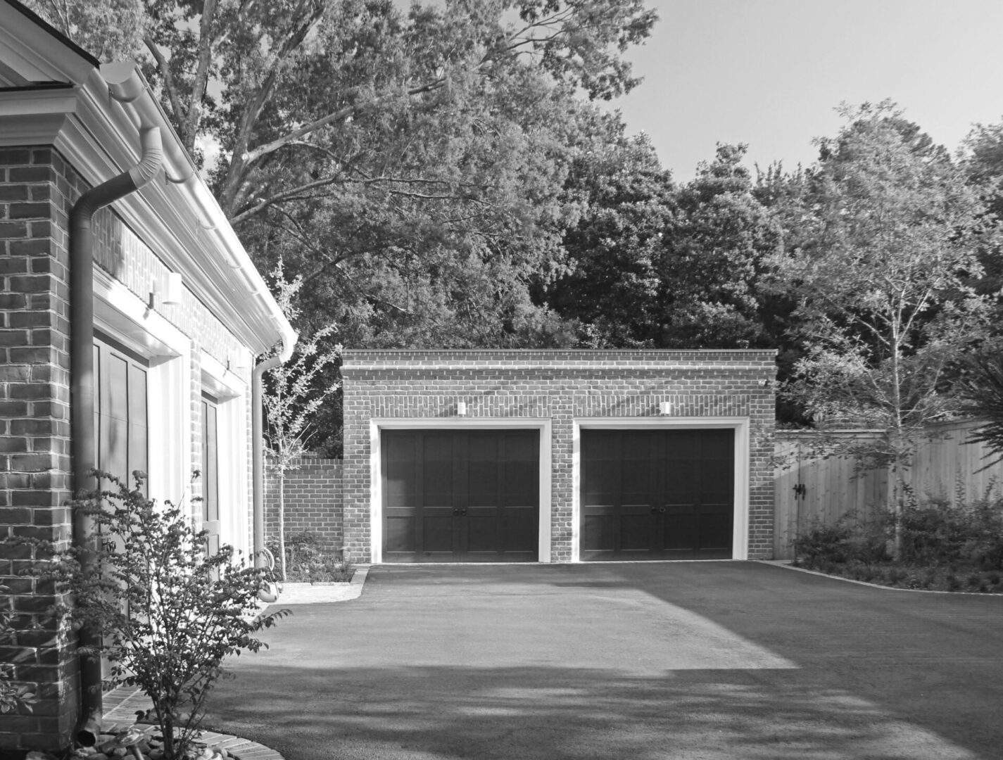 A black and white photo of two garages.