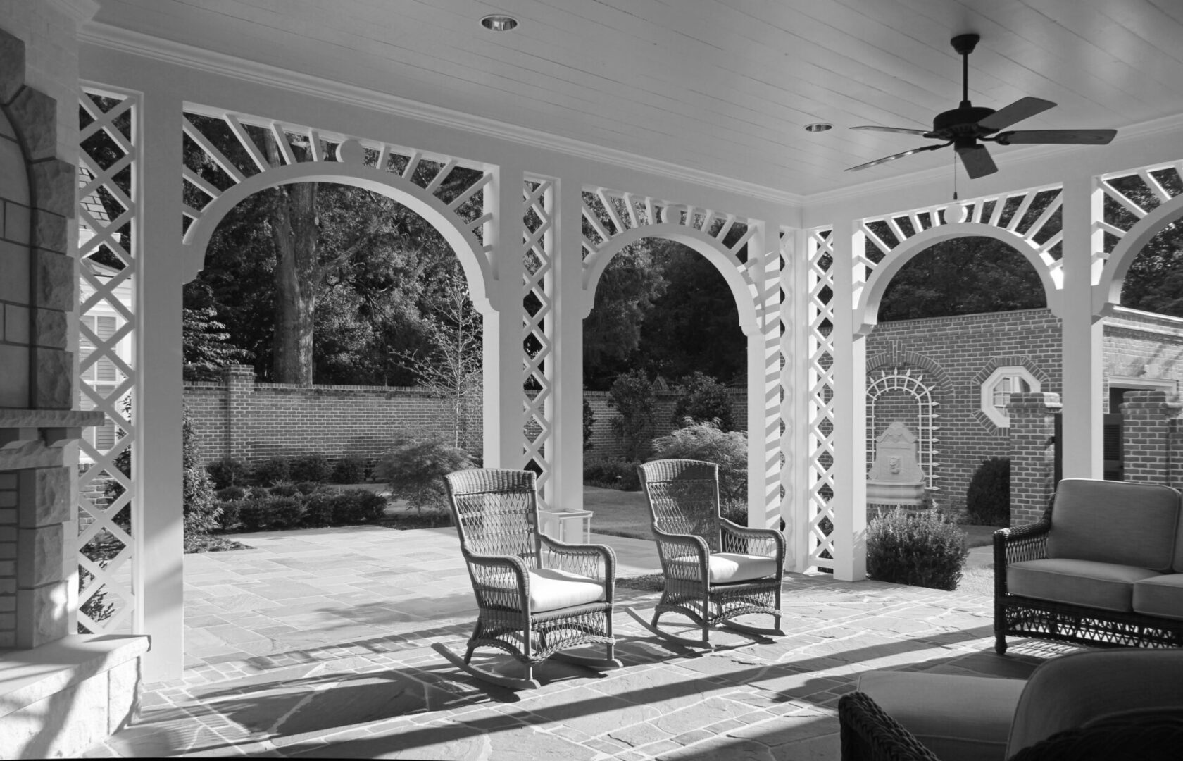 A black and white photo of two chairs on the patio.