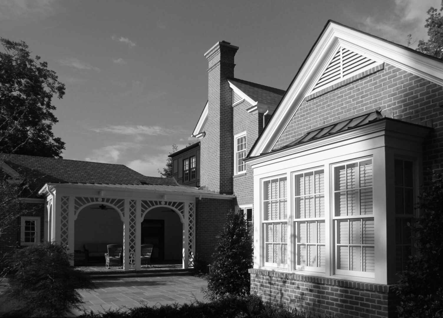 A black and white photo of two houses