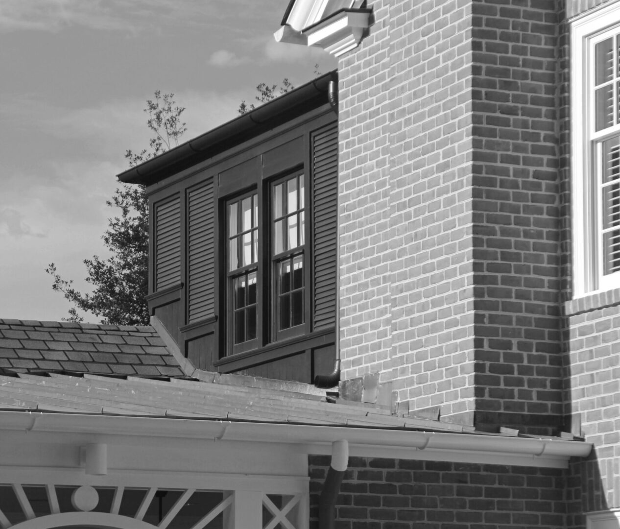 A black and white photo of a building with a light