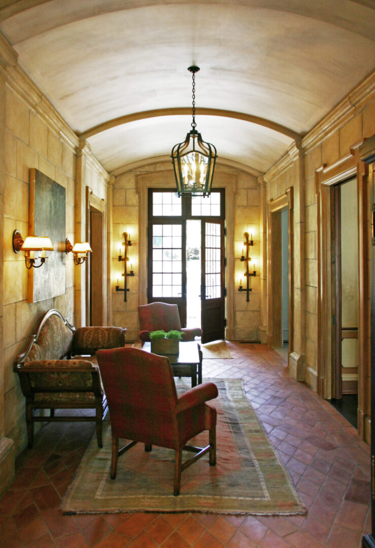 A hallway with chairs and tables in it