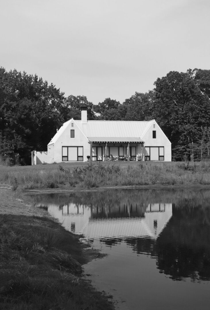 A house with a pond in the background.