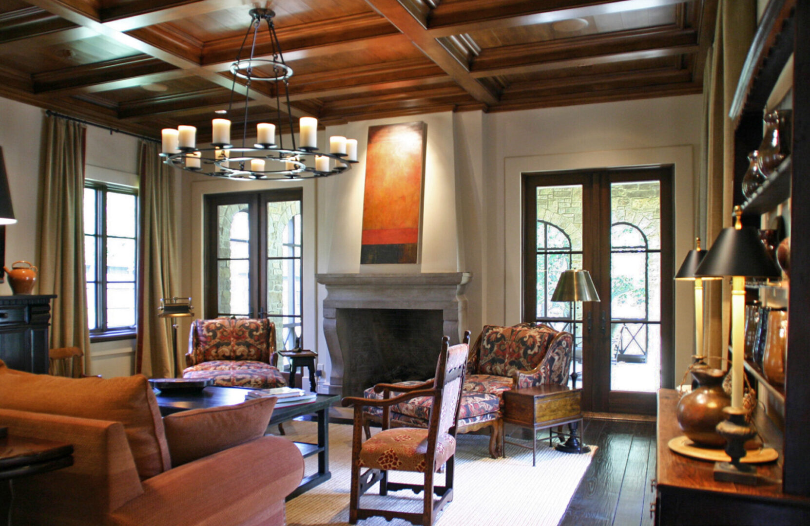 A living room with chairs, tables and fireplace.