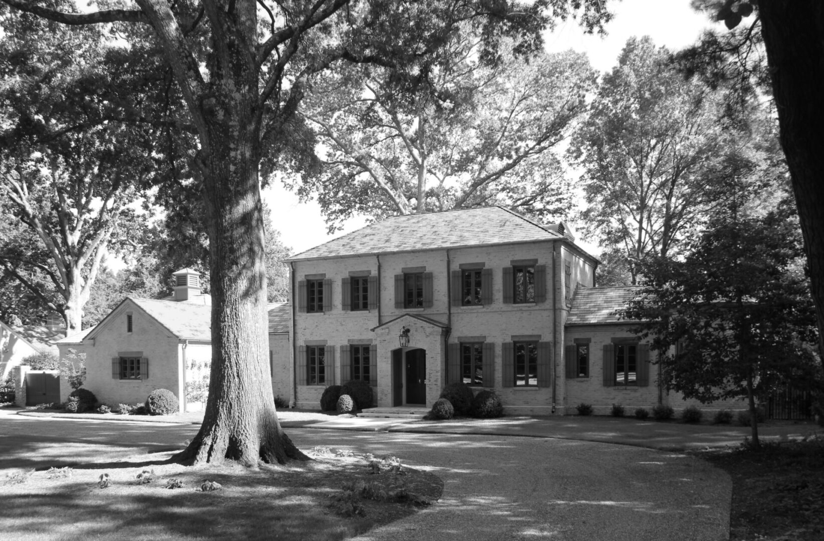 A black and white photo of an old house.