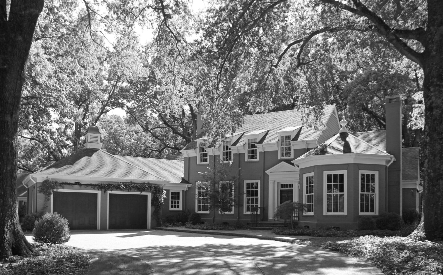 A large house with two garages in the front yard.