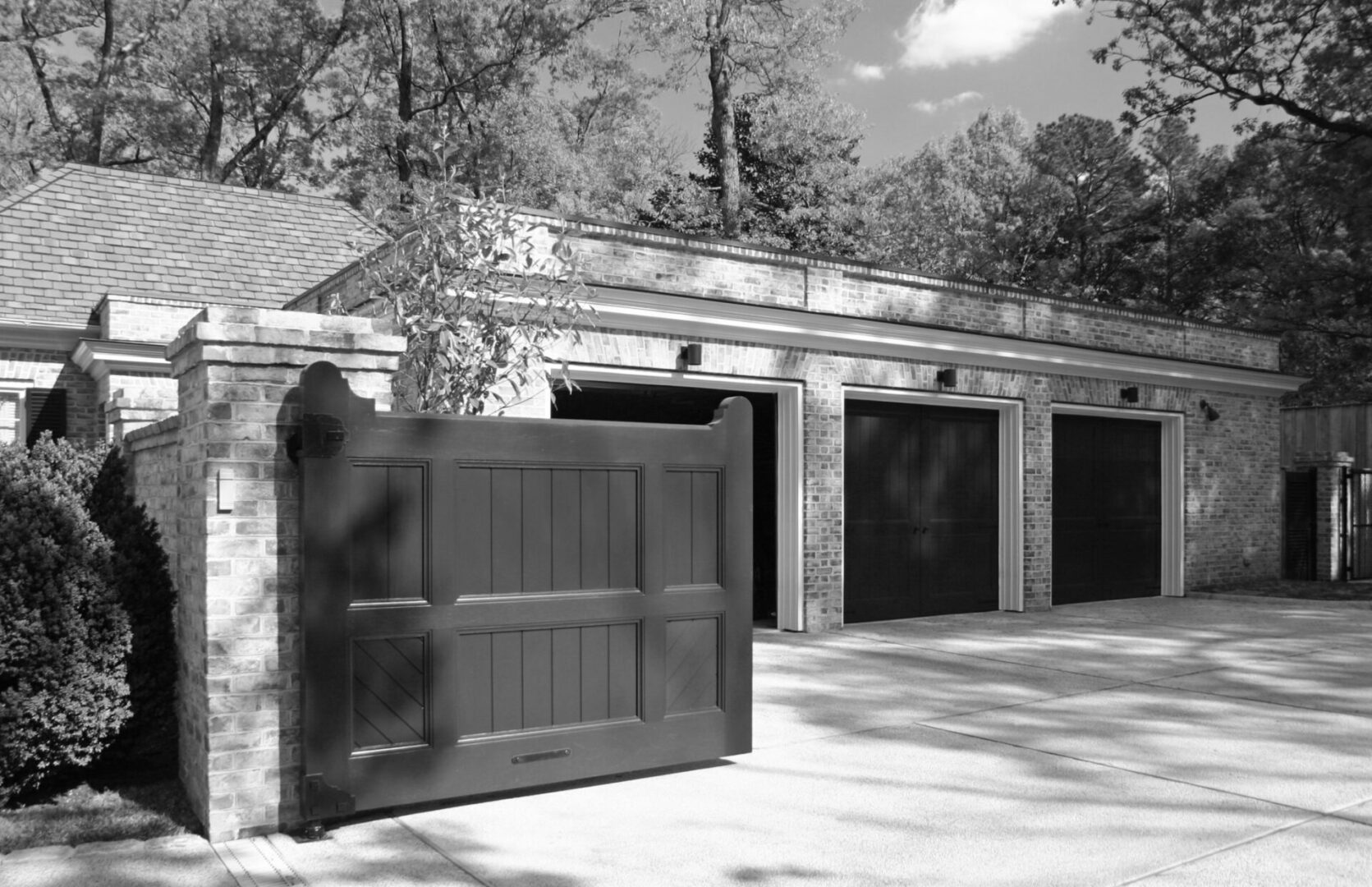 A black and white photo of a garage with two doors.