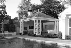 A black and white photo of an outdoor pool house.