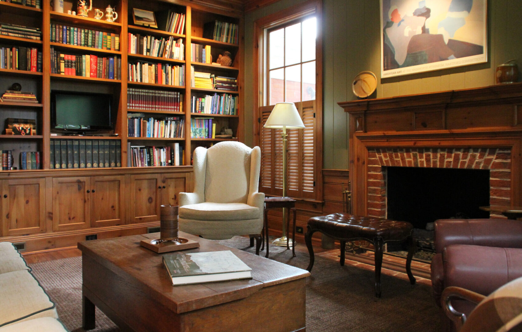 A living room with a fireplace and bookcases