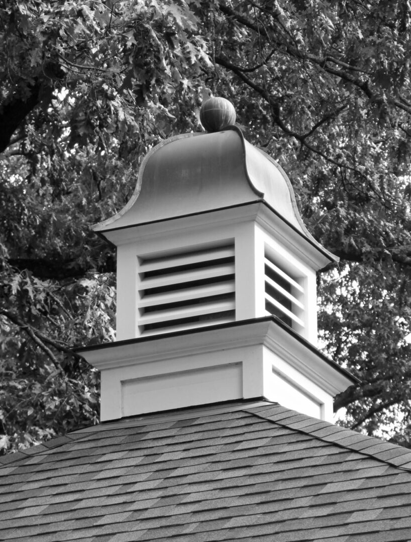 A black and white photo of the top of a building.