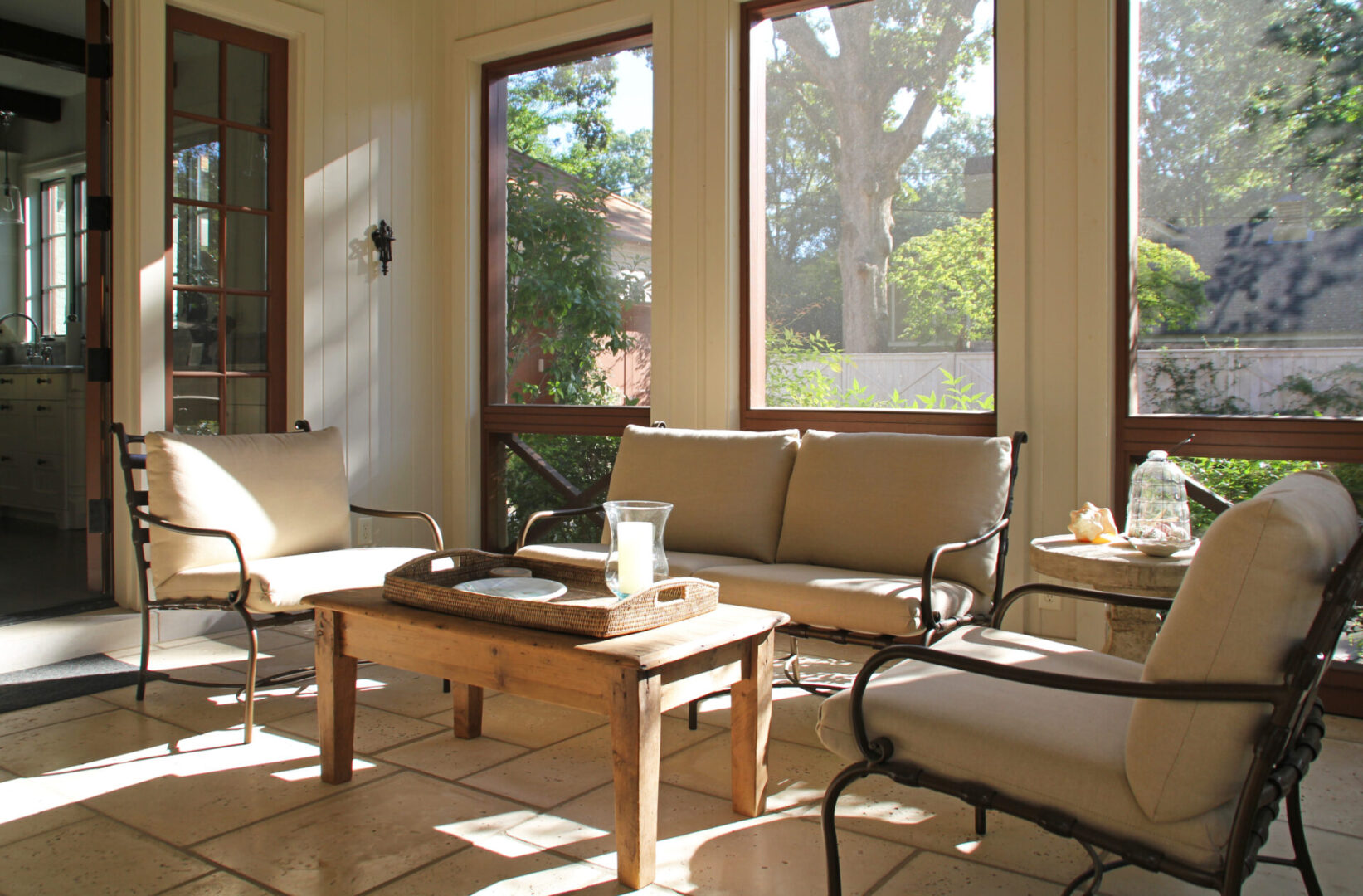 A living room with many windows and furniture