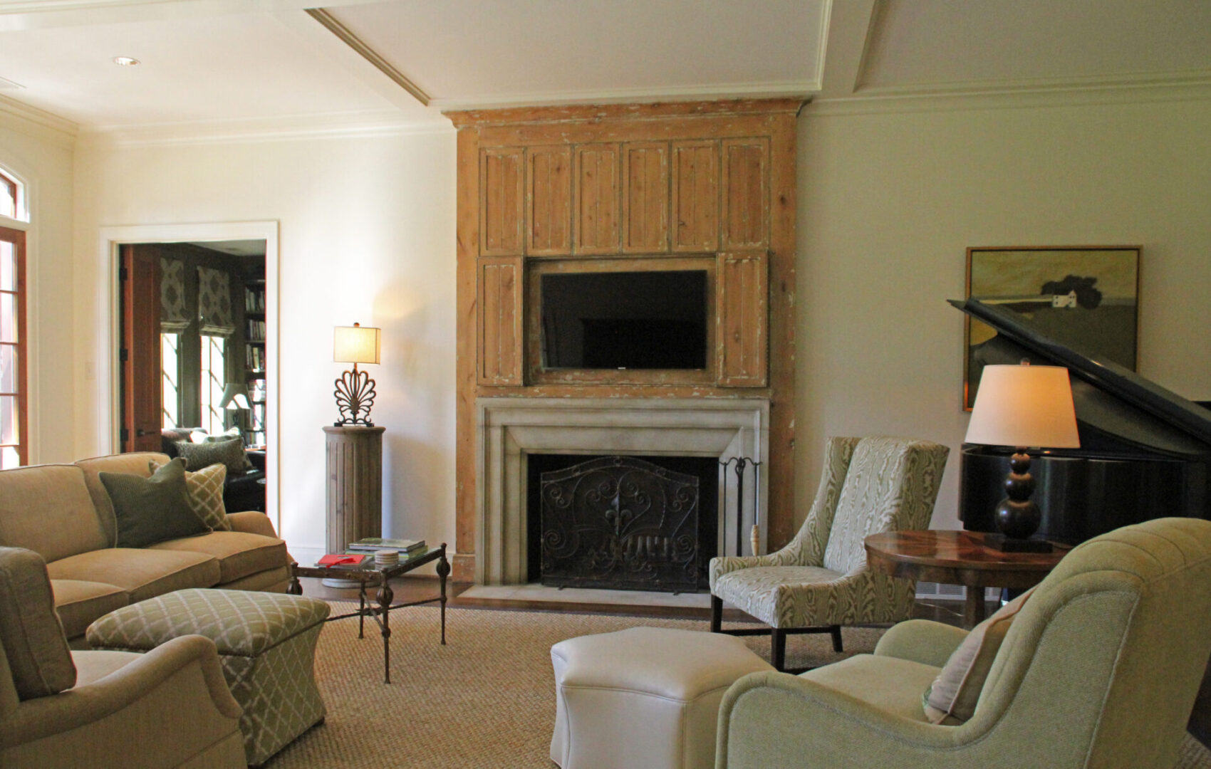 A living room with couches, chairs and a fireplace.