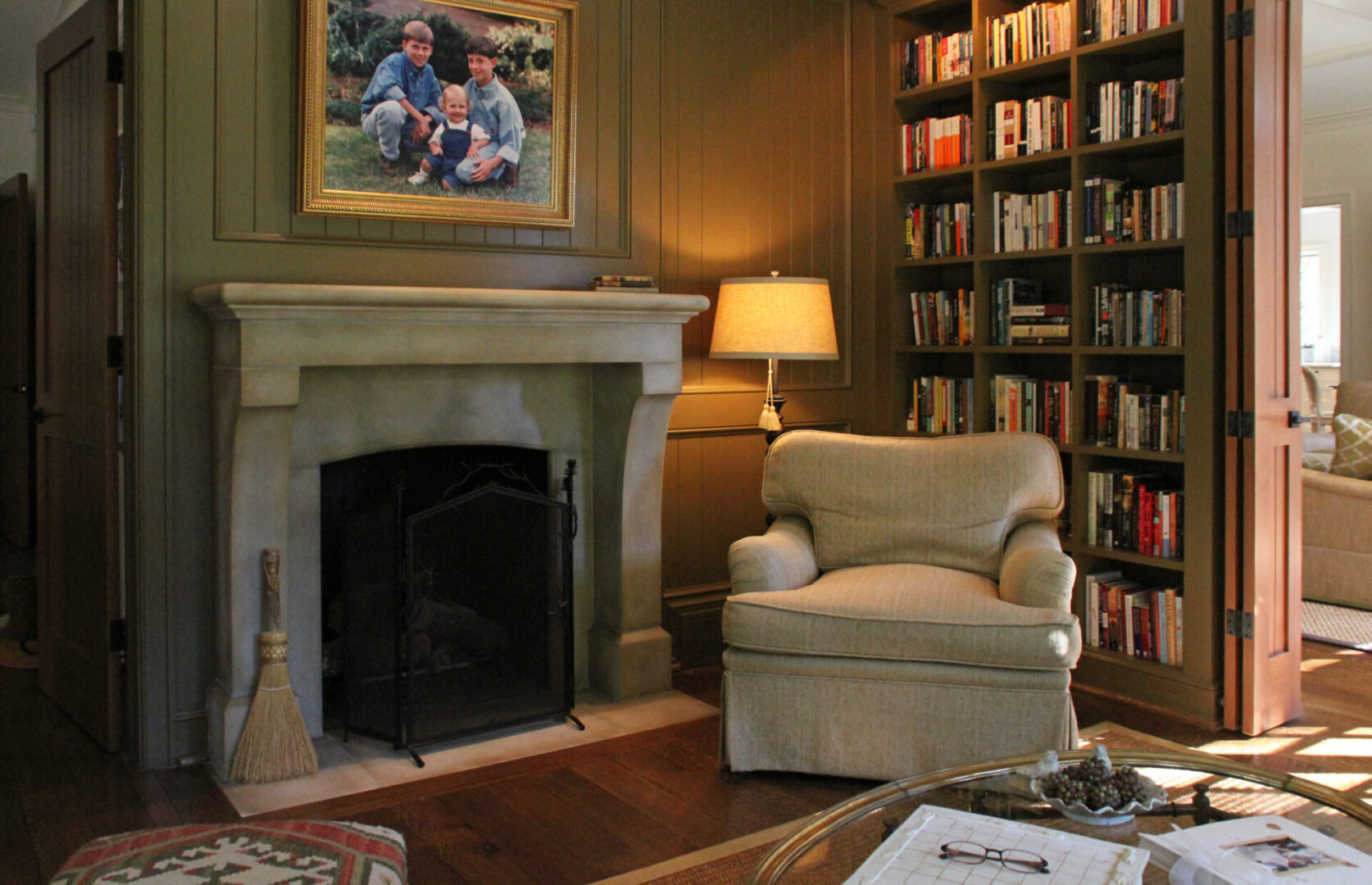 A living room with a fireplace and bookcases