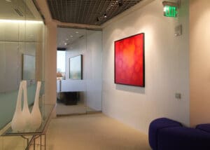 A room with a red painting on the wall