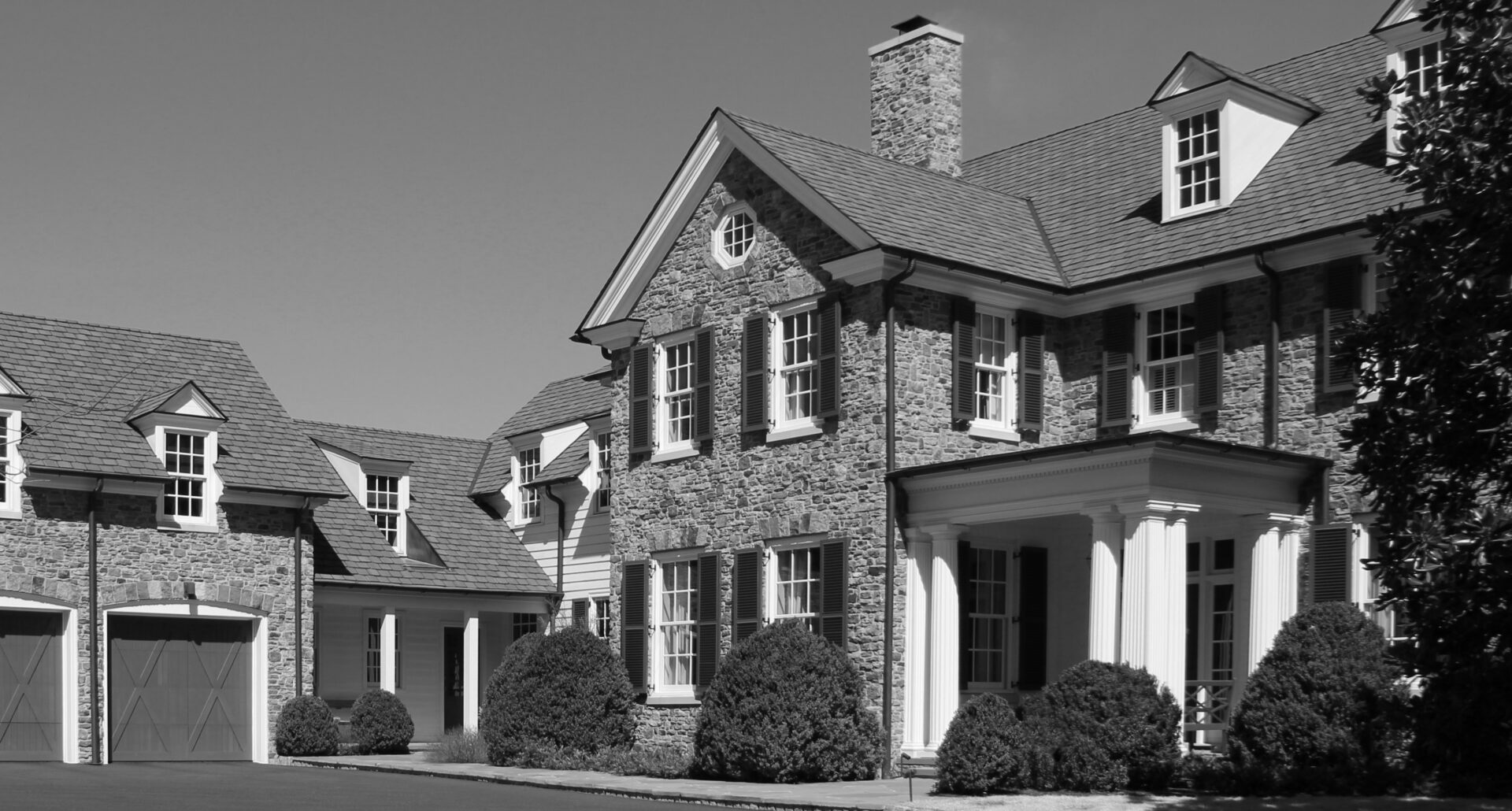 A black and white photo of a large house.