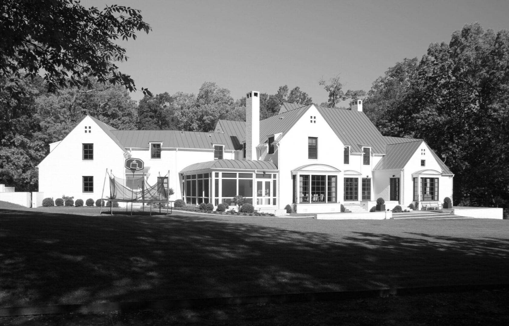 A black and white photo of a large house.