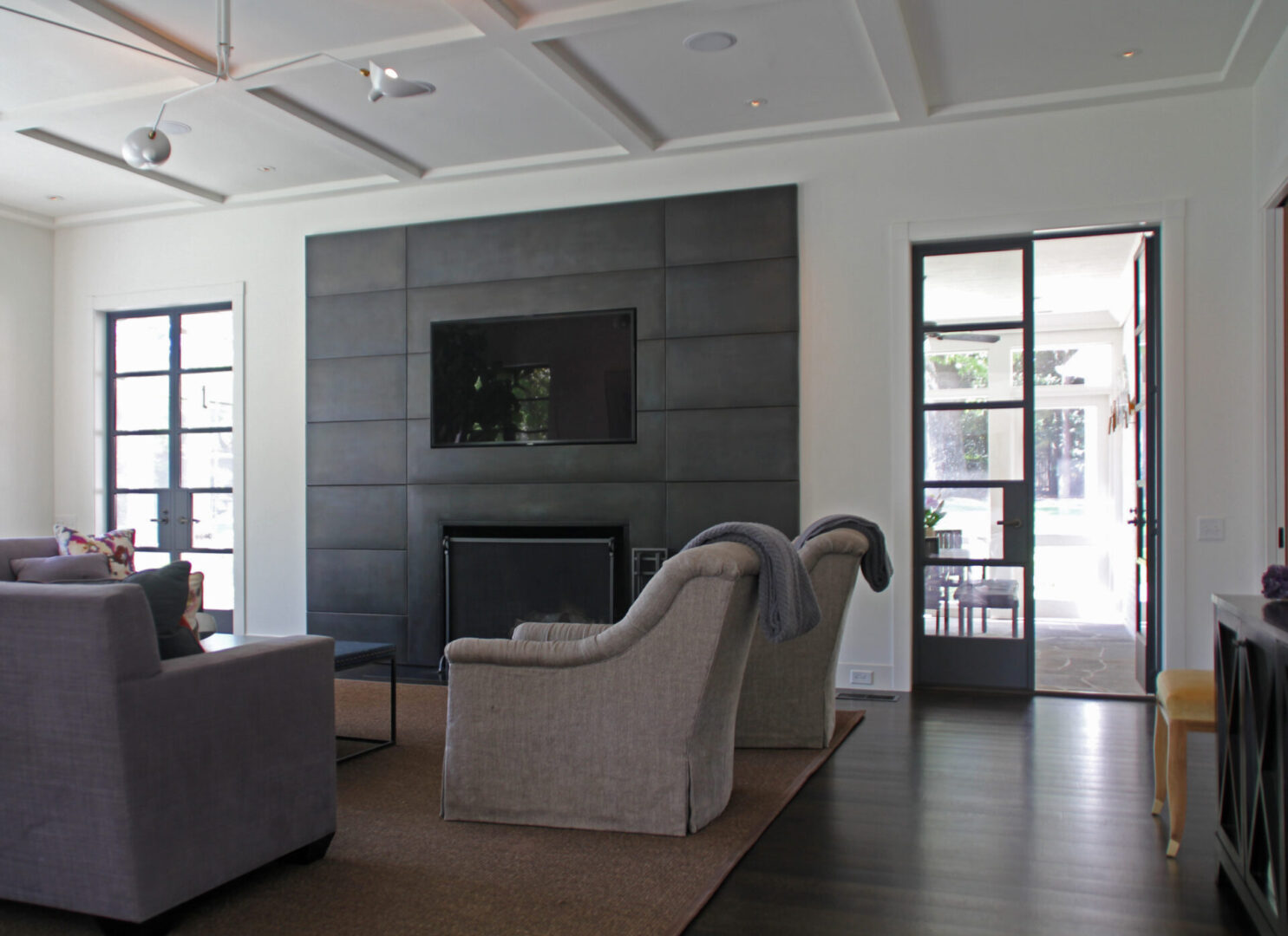 A living room with two chairs and a fireplace.