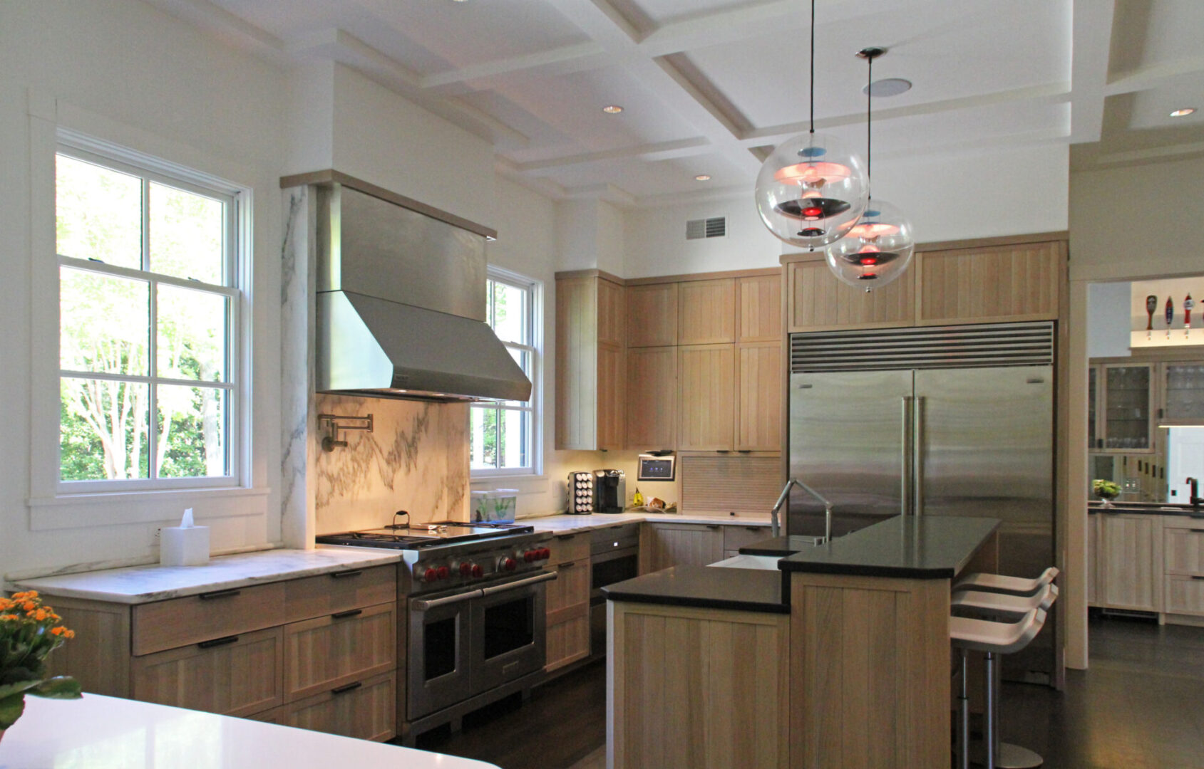 A kitchen with stainless steel appliances and wooden cabinets.